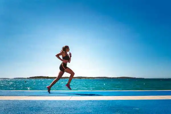 Woman running showing strong leg muscle Thrapston
